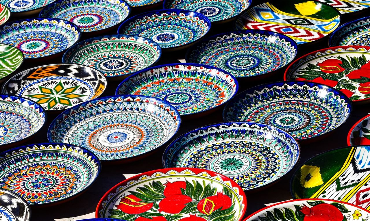 Vibrant hand-painted Uzbek ceramic plates showcasing traditional patterns in Bukhara, Uzbekistan.